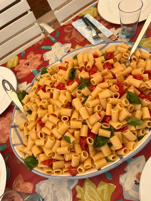 Sicilian pasta salad with Pachino cherry tomatoes and Pegaso extra virgin olive oil in a large bowl